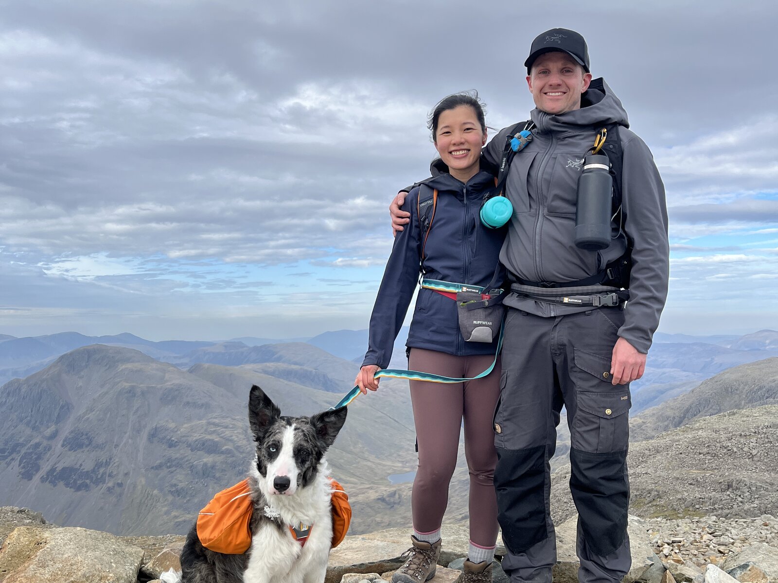 Ross and family on a mountain summit with their border collie