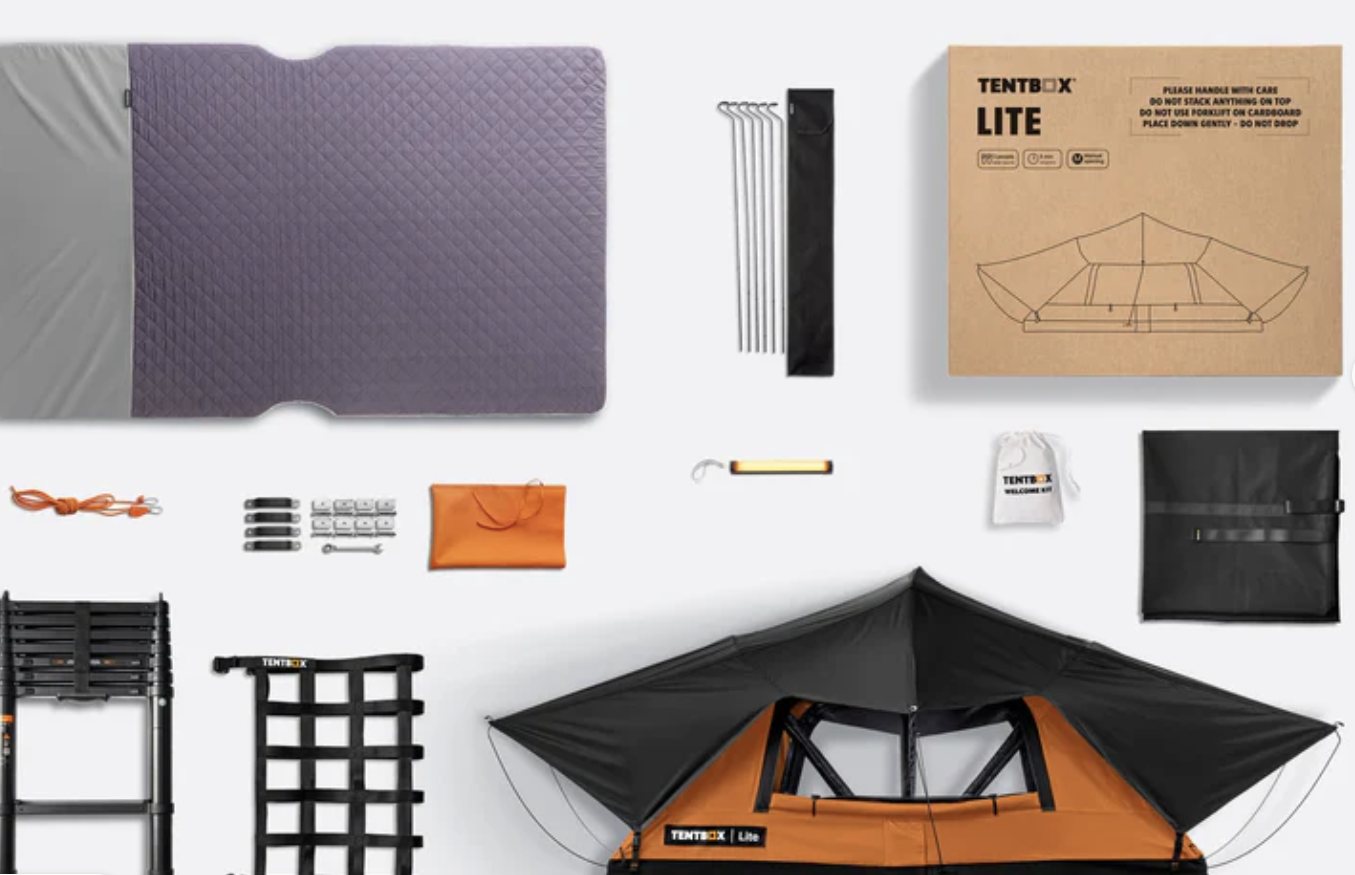 The rooftop tent and its supplied kit laid out: mattress, telescopic ladder, guy lines, pegs, storage bag and interior light